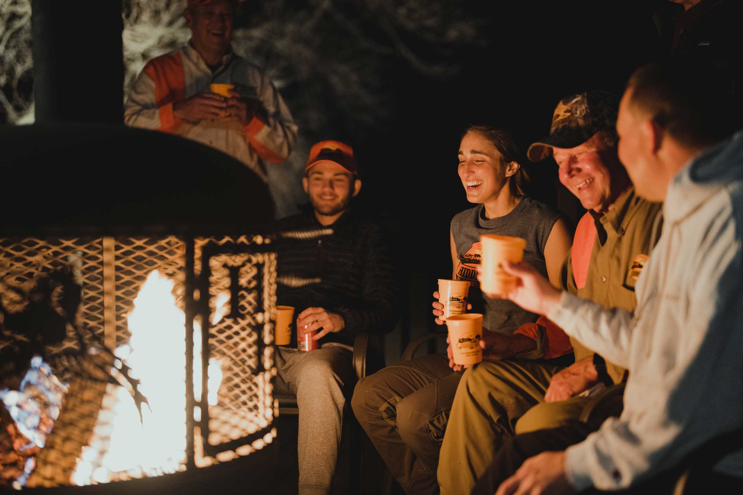 Group of pheasant hunters gathered around a fire