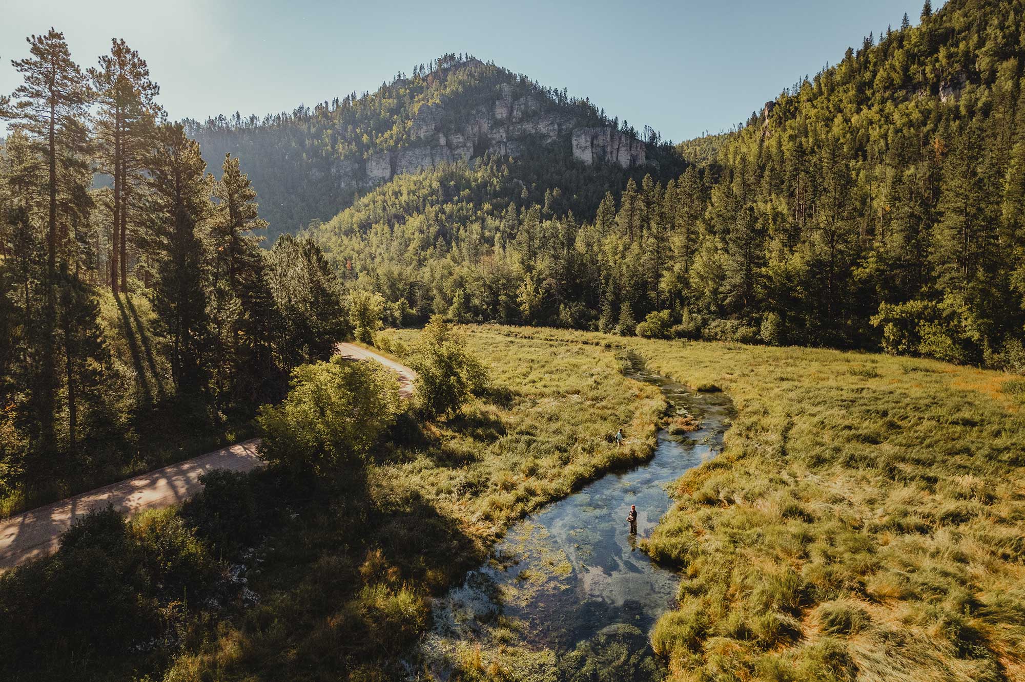 A person fly-fishes on Spearfish Creek in scenic Spearfish Canyon