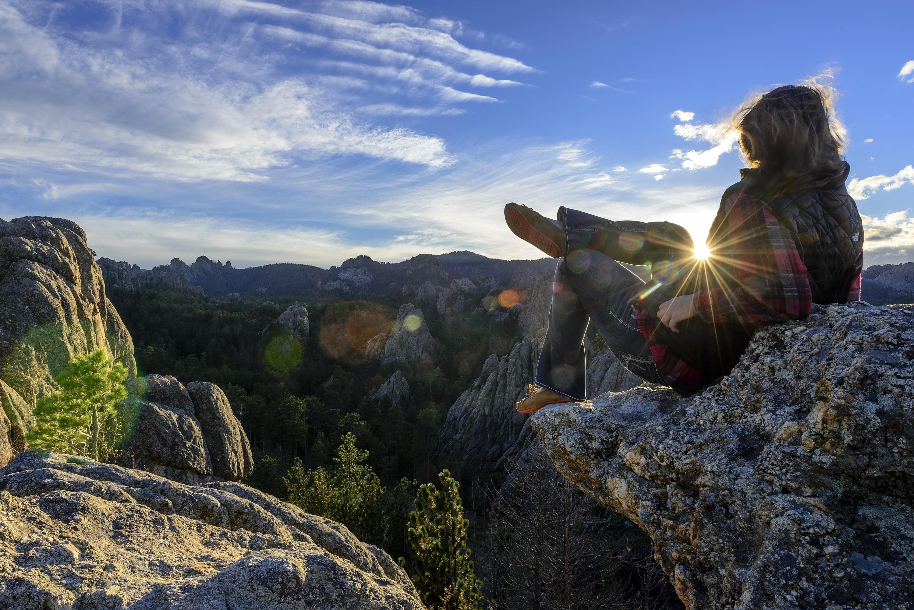 A hiker takes in an incredible view from the mountains of western South Dakota