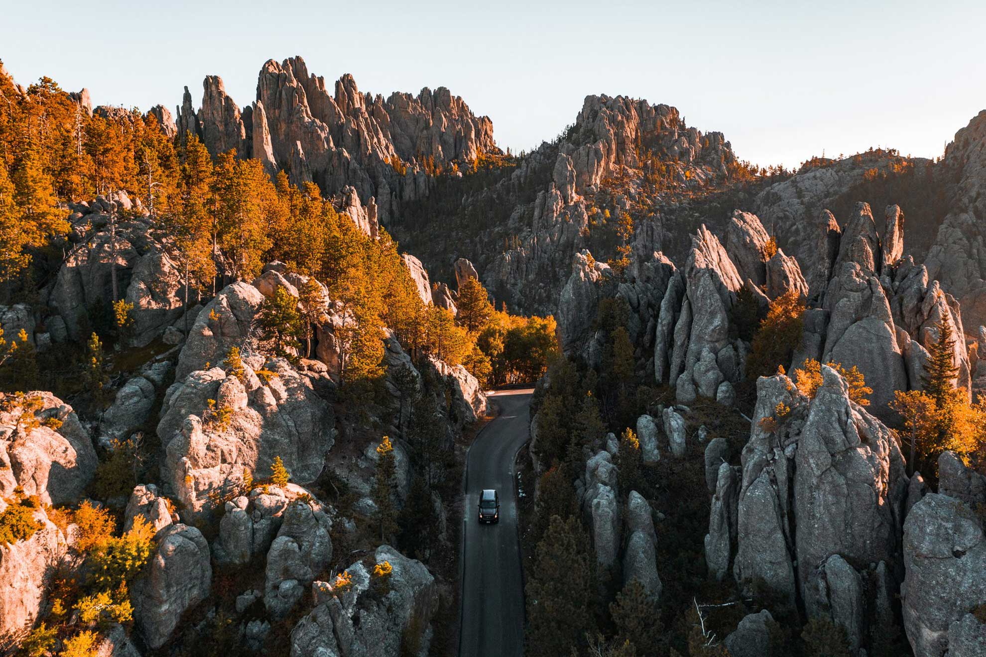 Overhead view of a car traveling on the Needles Highway, surrounded by granite spires. Black Hills South Dakota.