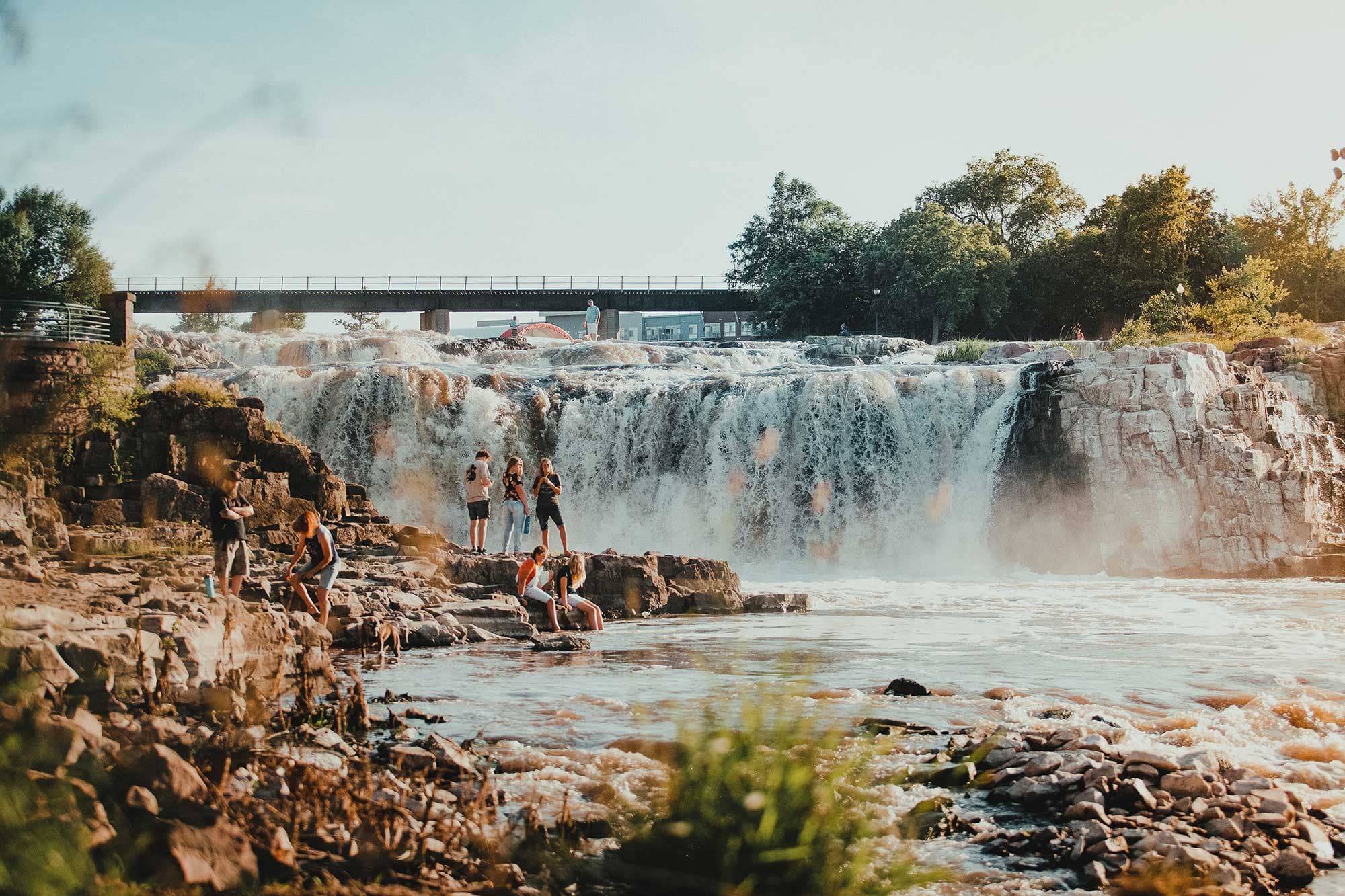 People explore the rocks at Falls Park in Sioux Falls, SD
