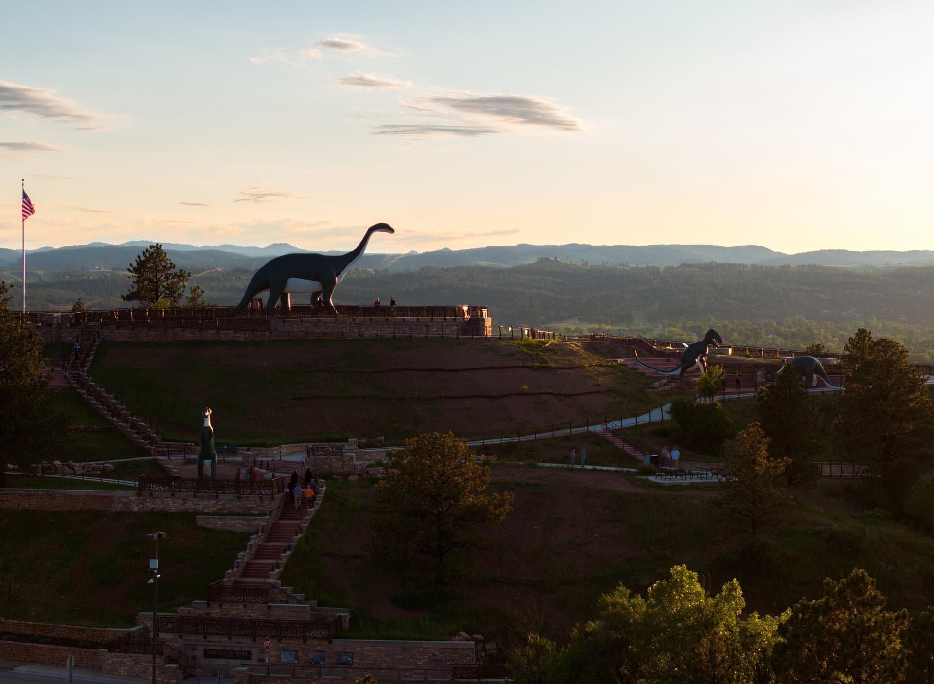 The silhouette of a brontosaurus sculpture looks out from Dinosaur Hill in Rapid City