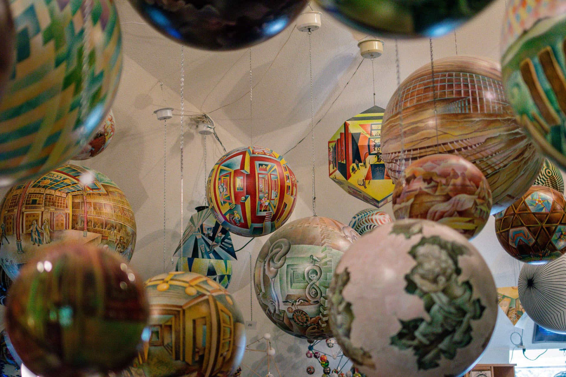 Painted spheres dangle from a canvas ceiling at Termesphere Gallery in Spearfish, SD