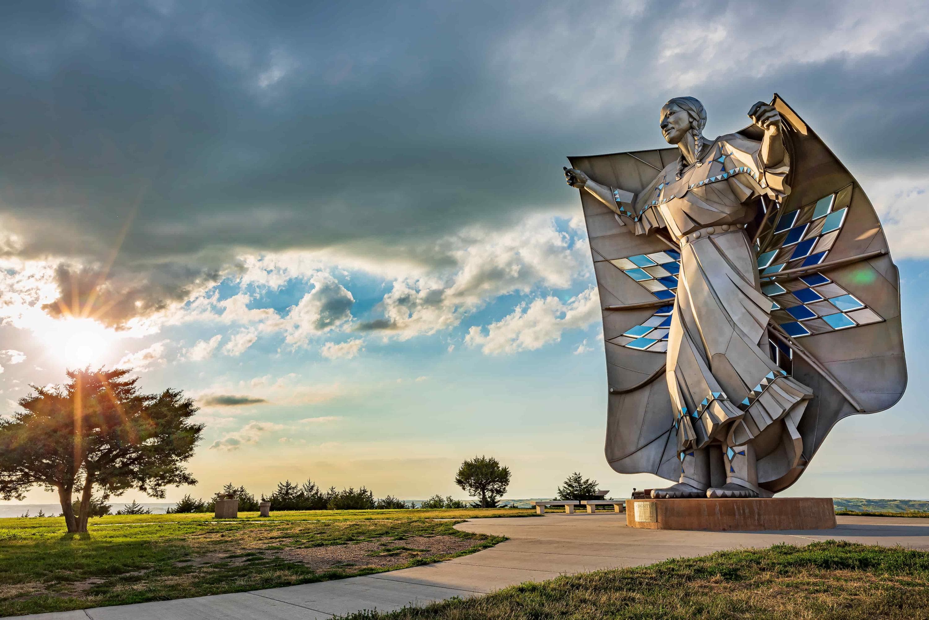 The Dignity: Of Earth & Sky statue is illuminated by a scenic sunset. Chamberlain, South Dakota