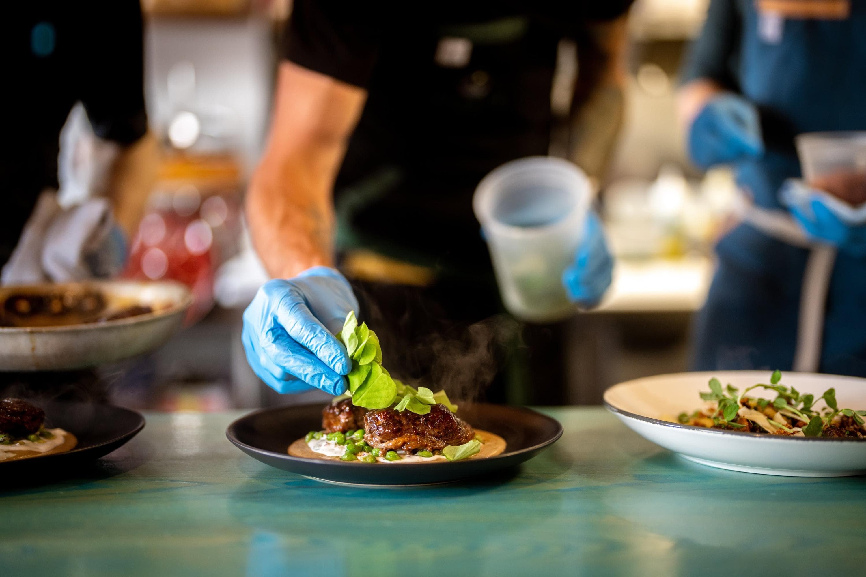 A chef's hands put the finishing touches on a dish at Skogen Kitchen in Custer, South Dakota.