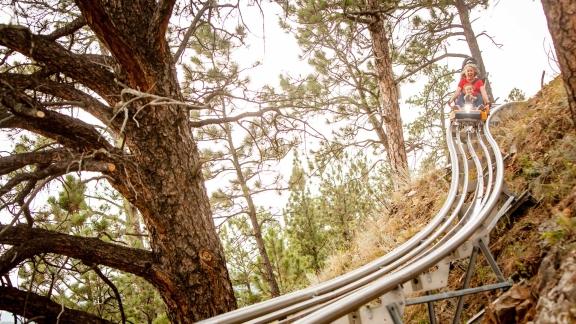 Mom and child going down an alpine slide