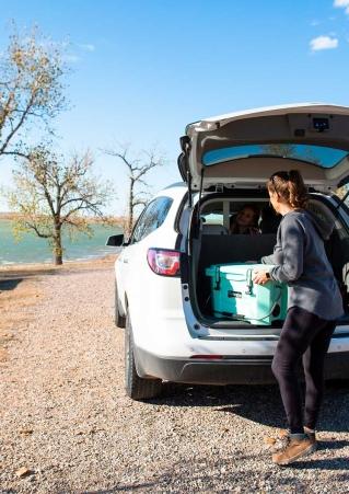 Woman removing cooler from car at Rocky Point Recreation Area