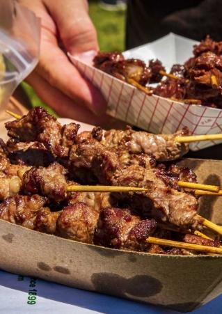 Close up of two containers of chislic, a South Dakota culinary specialty consisting of chunks of meat on skewers. South Dakota Chislic Festival, Freeman, SD.