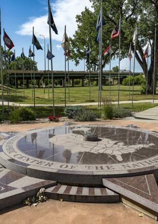 The Geographic Center of the Nation Monument is flanked by U.S. flags in Belle Fourche, SD.