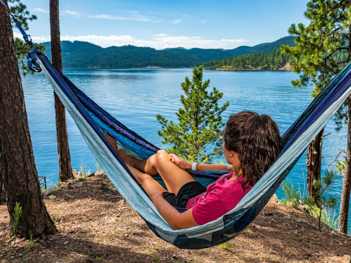 Girl in hammock overlooking lake
