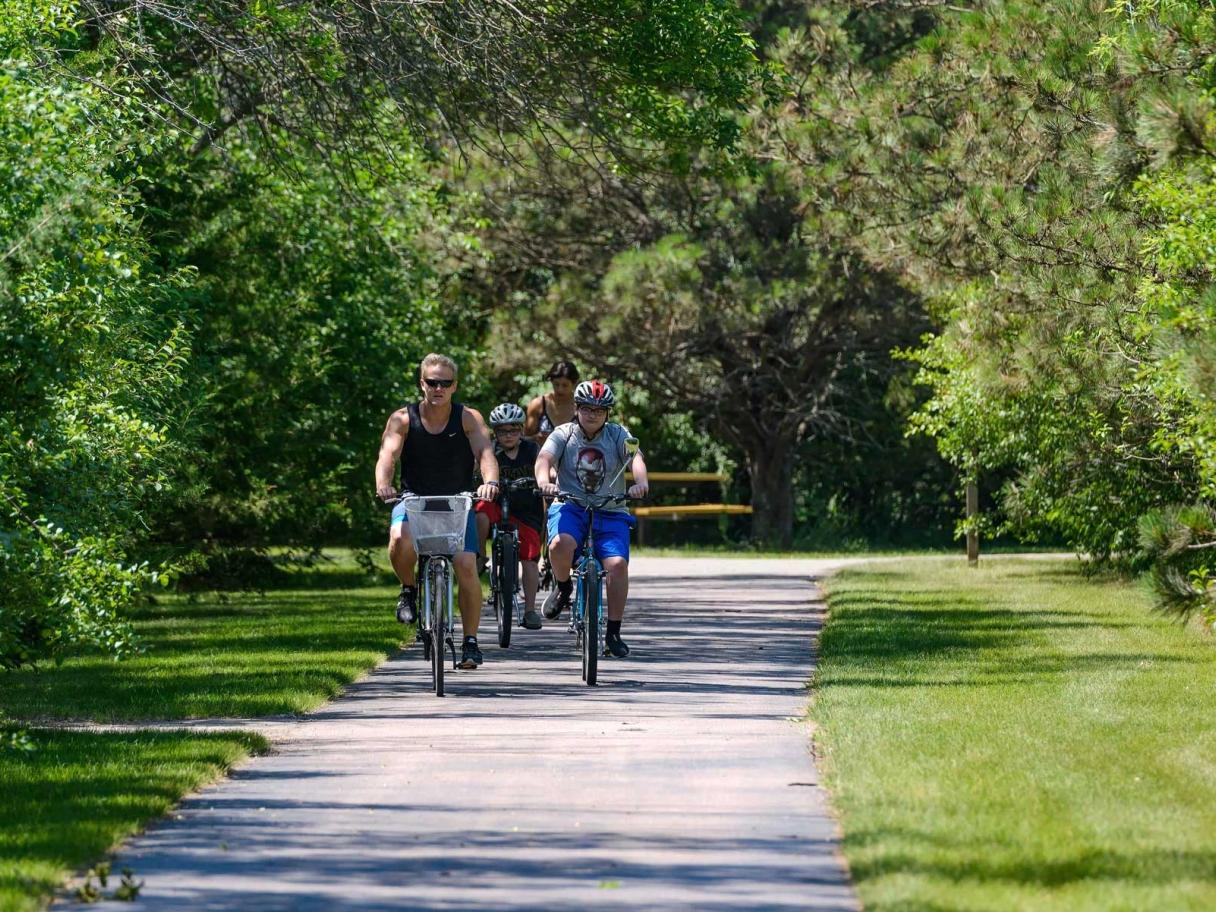Family biking on path at Dakota Nature Park
