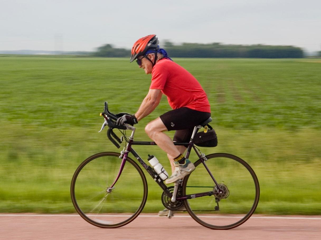 Man biking on country road near Miller