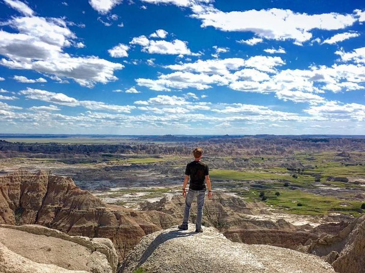 Man overlooking badlands