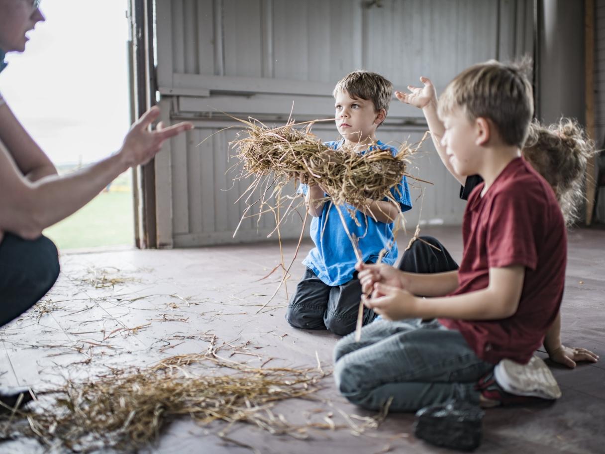 Children twisting hay
