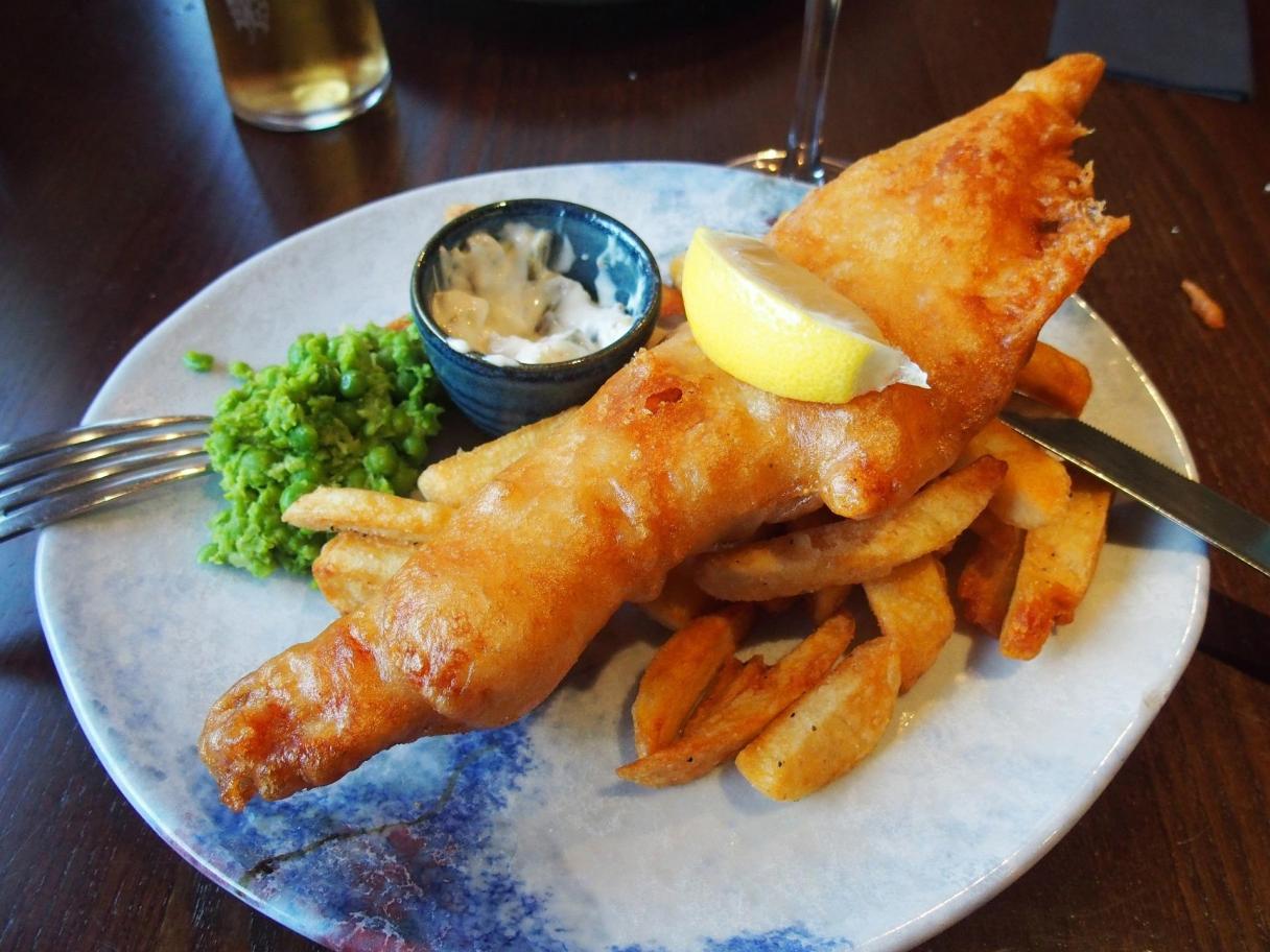 Fried fish with fries and sauce on side
