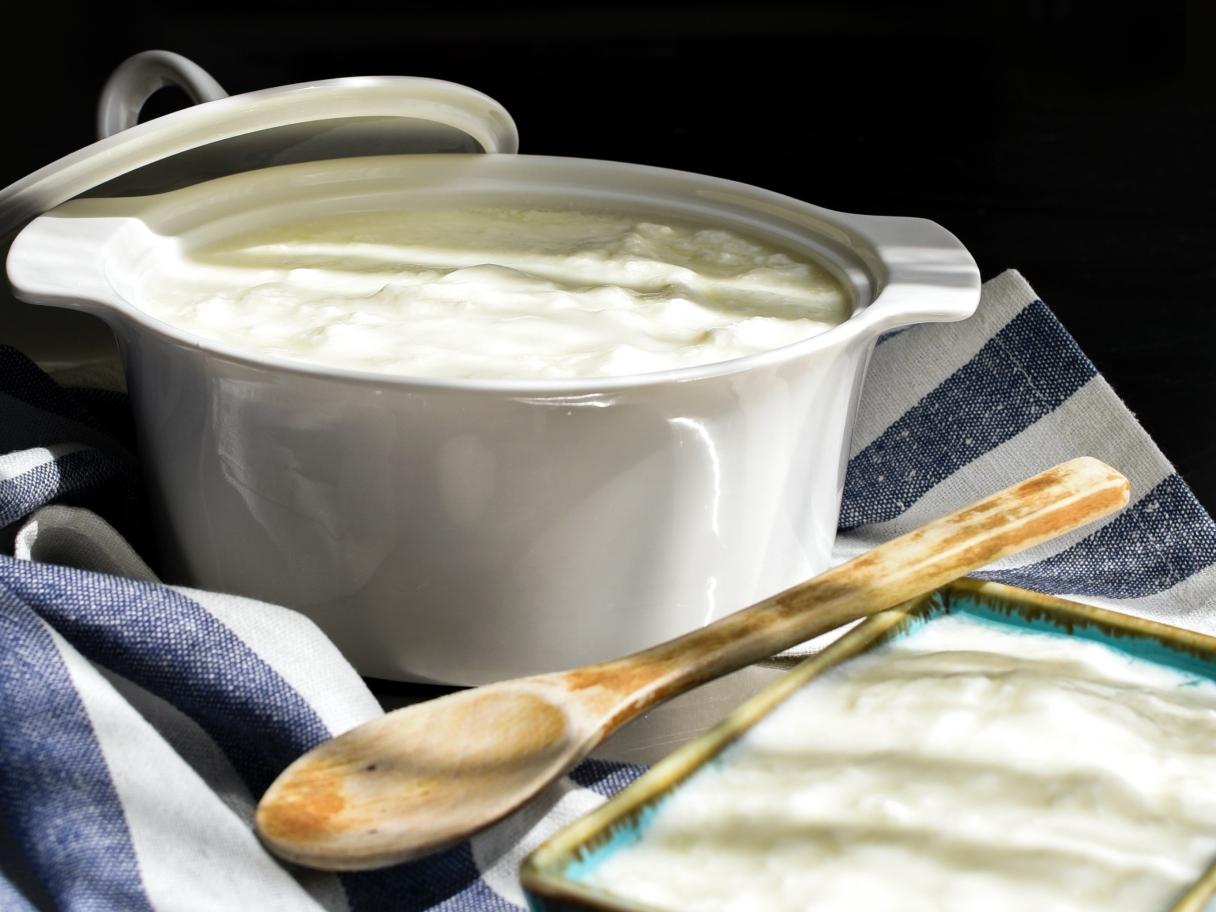 Chowder in pot with wooden spoon by Elif Tekkaya