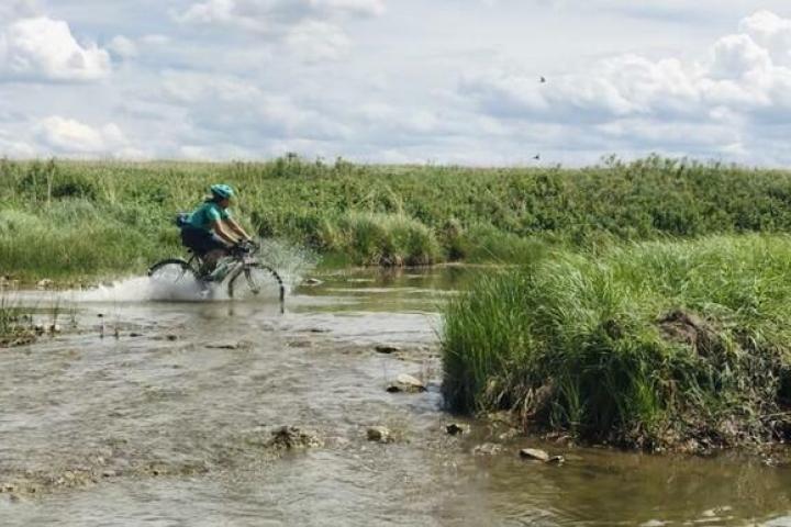 Cyclist blasting through water in NW SD
