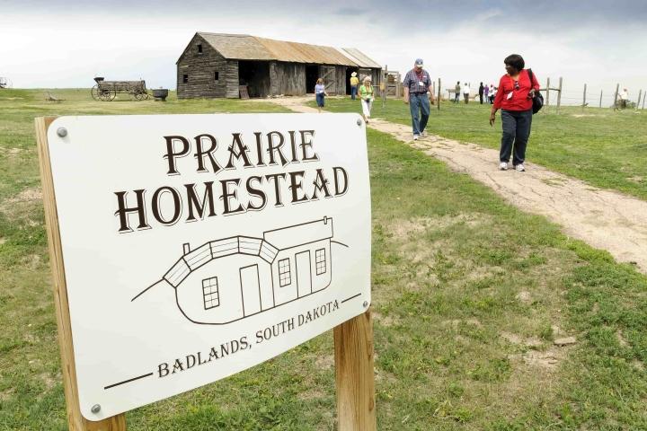 Prairie Homestead sign with people