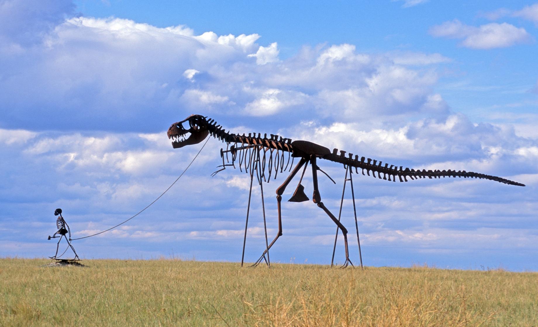 Dinosaur and man sculpture