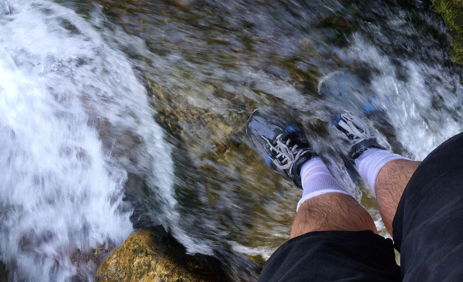 Shoes in water at Devils Bathtub