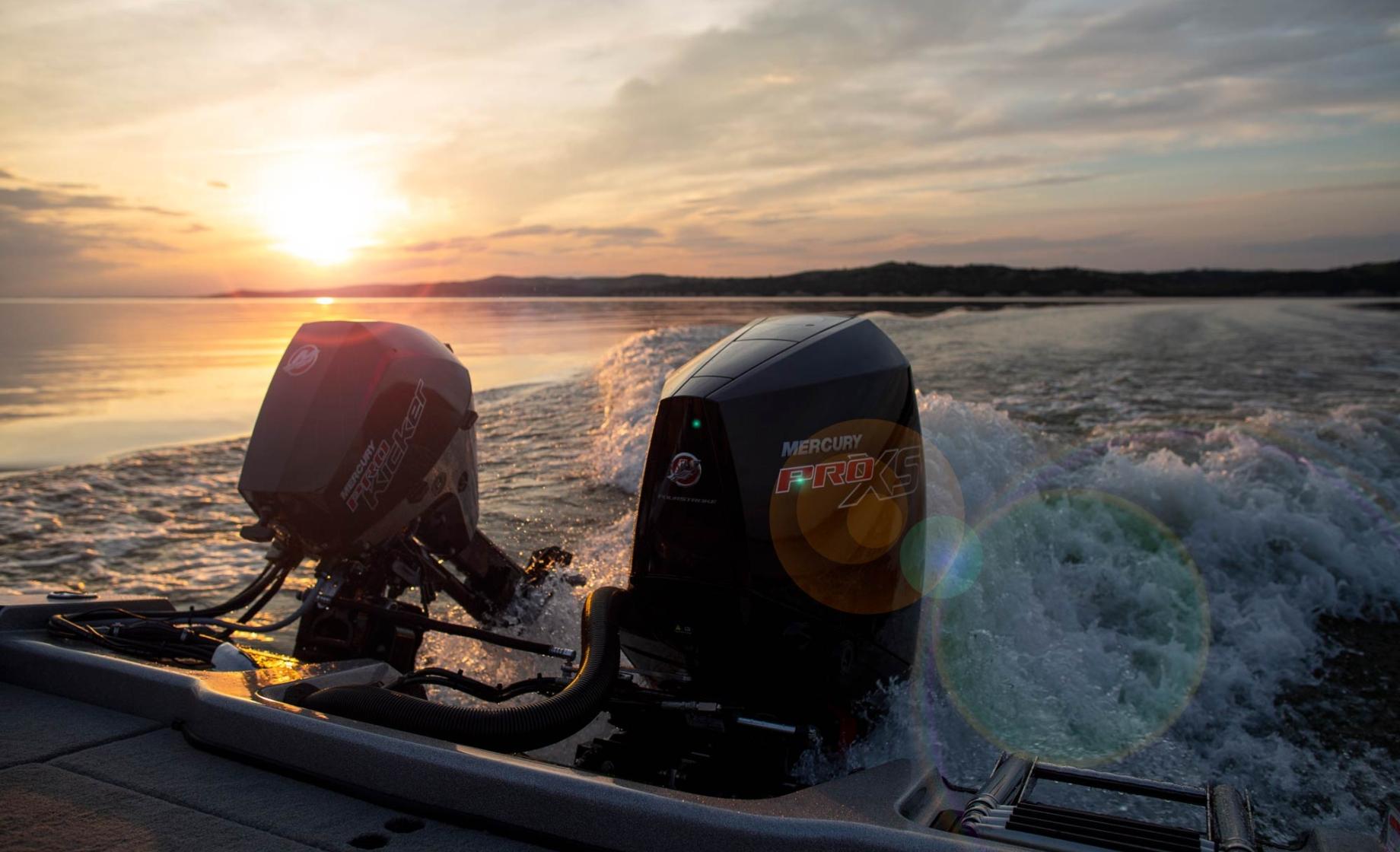 Sunrise over lake looking off the back of a boat