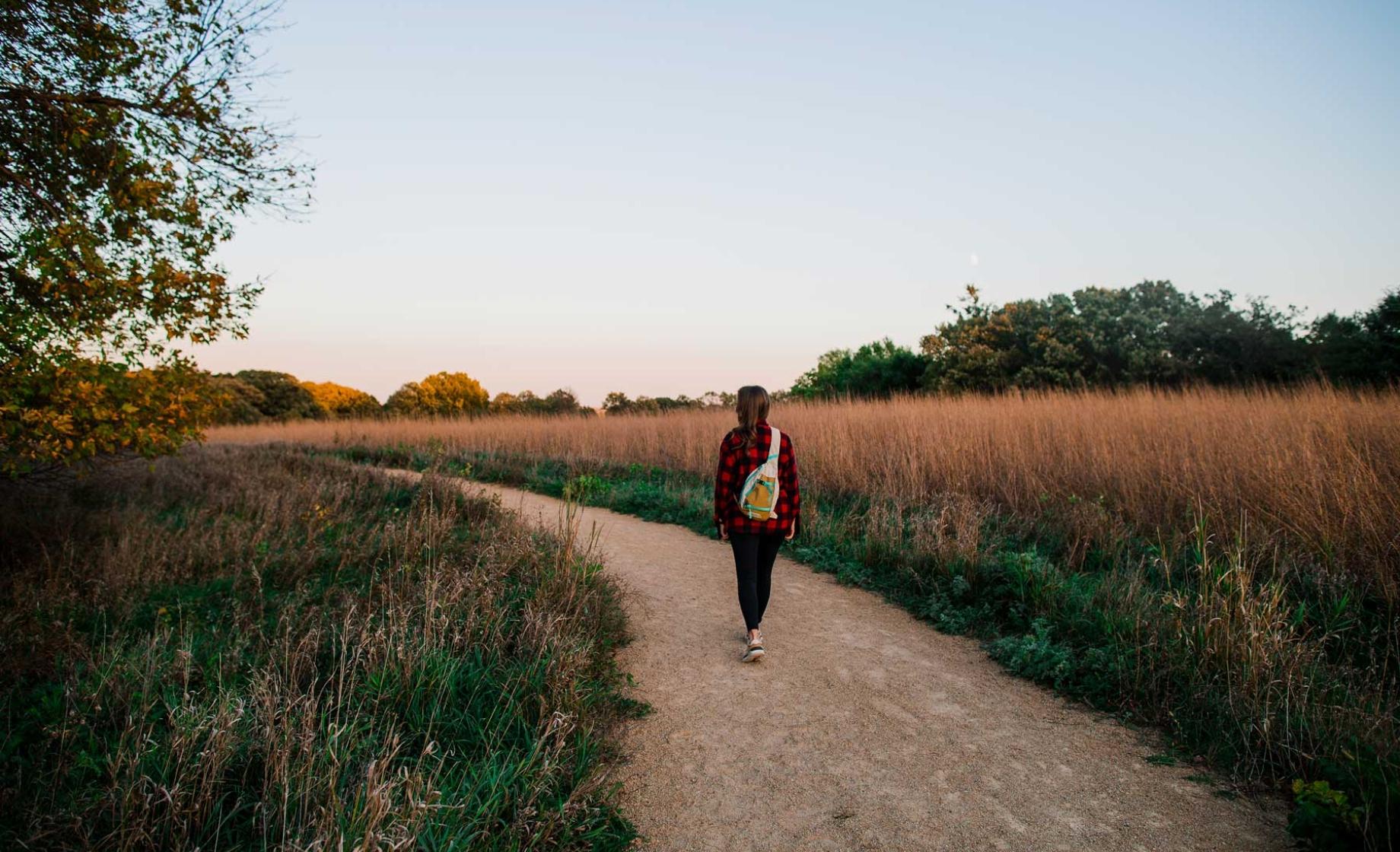 Woman walking away on hiking trail