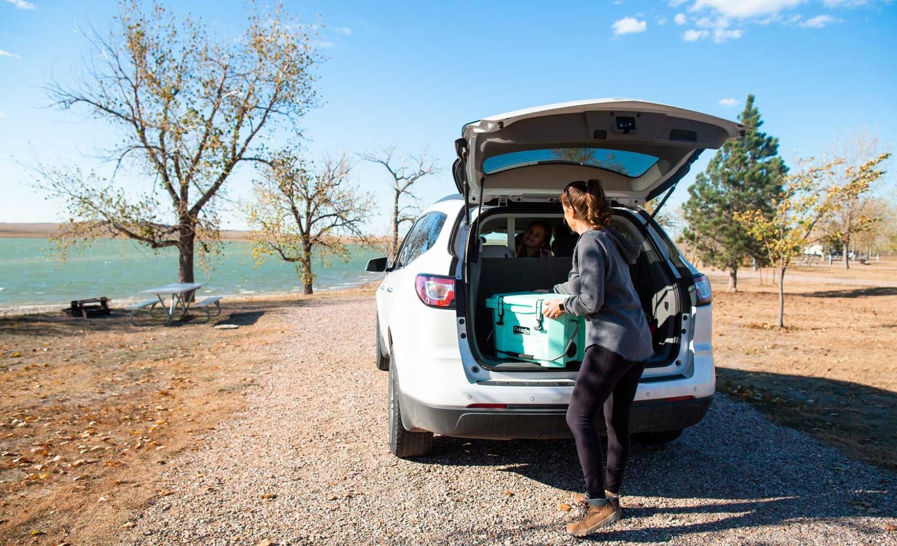 Woman removing cooler from car at Rocky Point Recreation Area