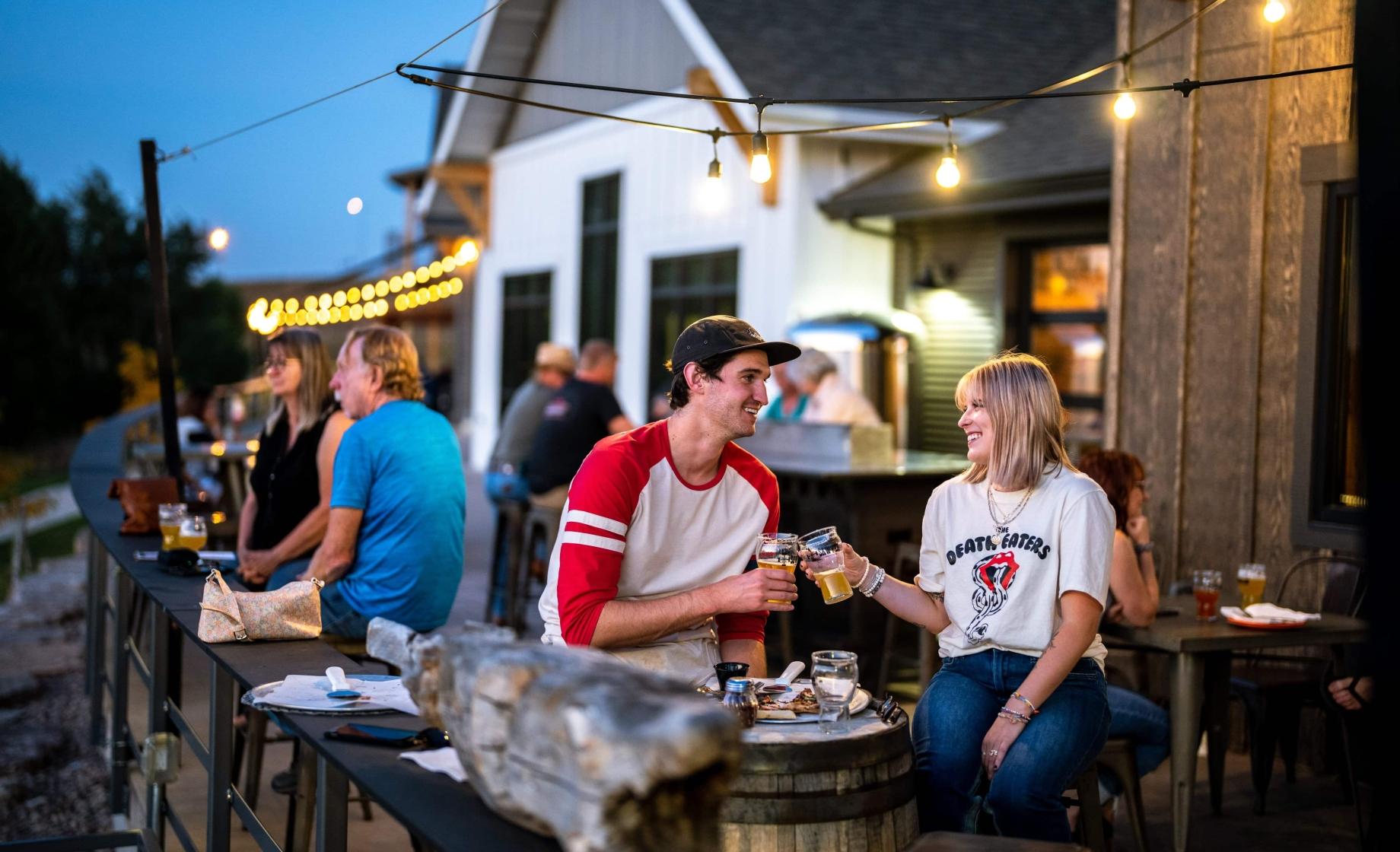 A couple enjoys a beer outdoors at Sawyer Brewing in Spearfish