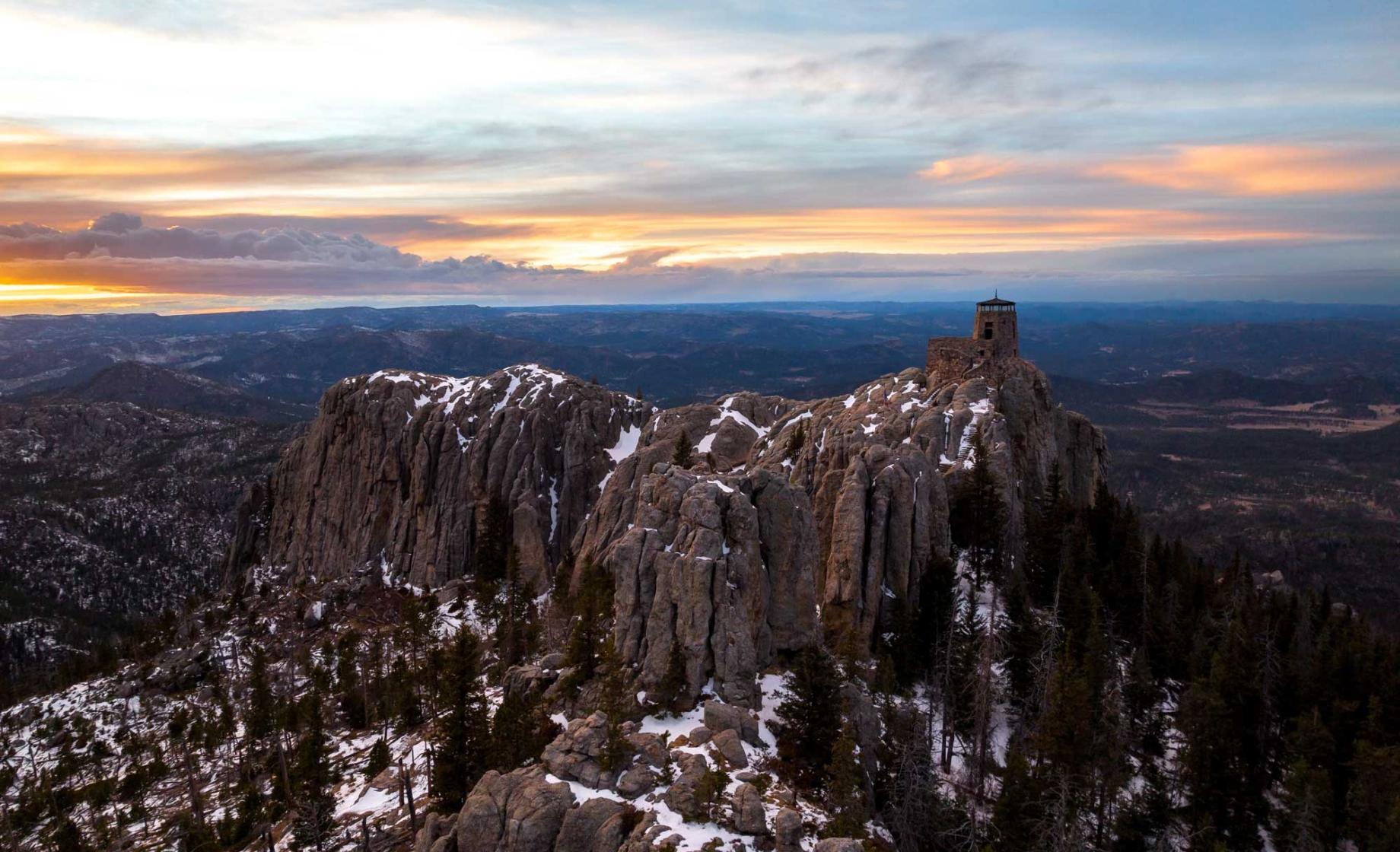Aerial view of Black Elk Peak covered in snow at sunrise