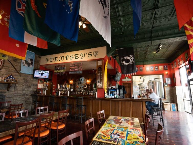 The interior of Dempsey’s Brewery, Pub & Restaurant in Watertown, South Dakota, is decorated with colorful flags, posters and photographs.