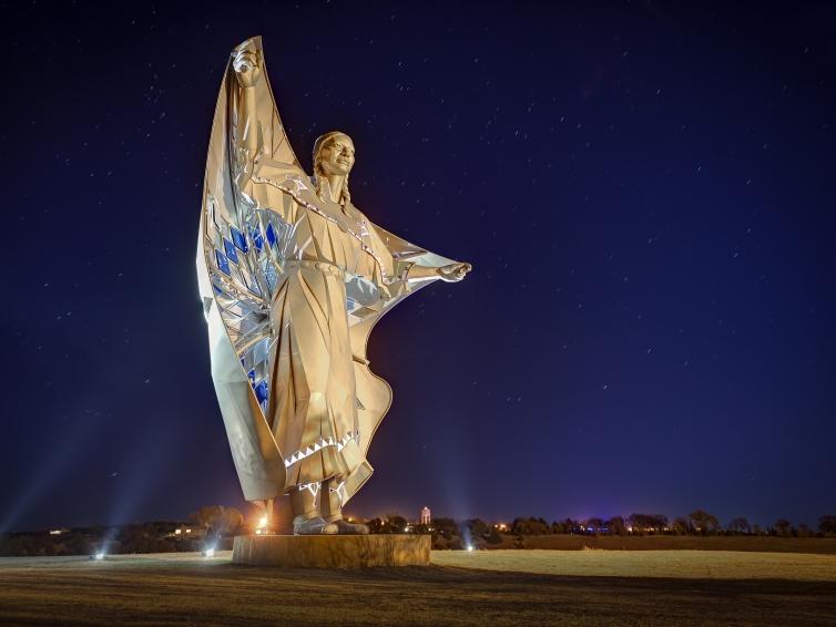 Dignity sculpture at night