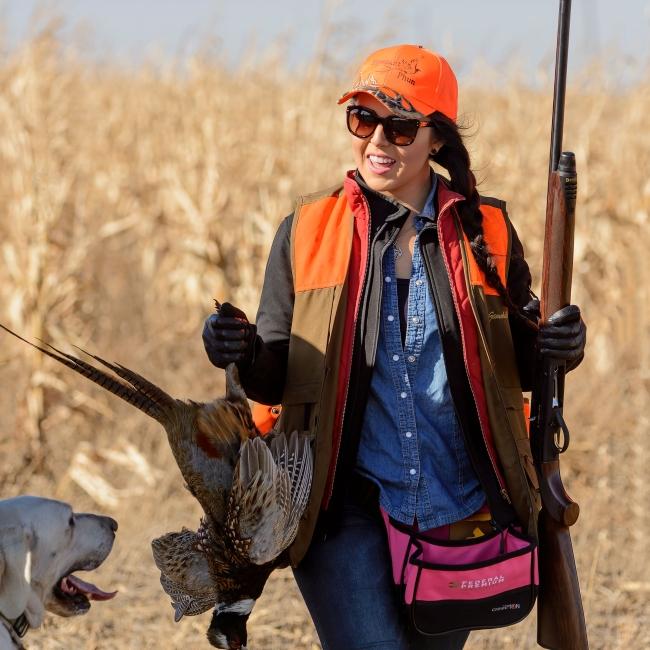 female hunter with rooster and dog