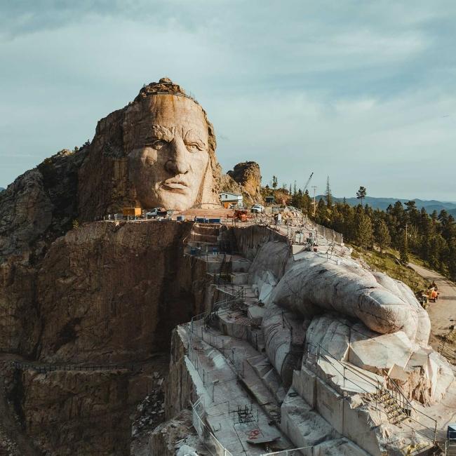 A striking view of the face and outstretched hand of Crazy Horse Memorial®. Crazy Horse, SD.