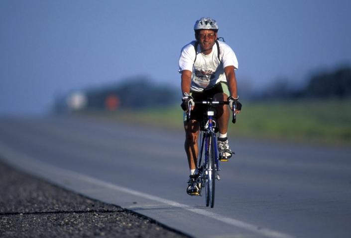 Man biking on a road