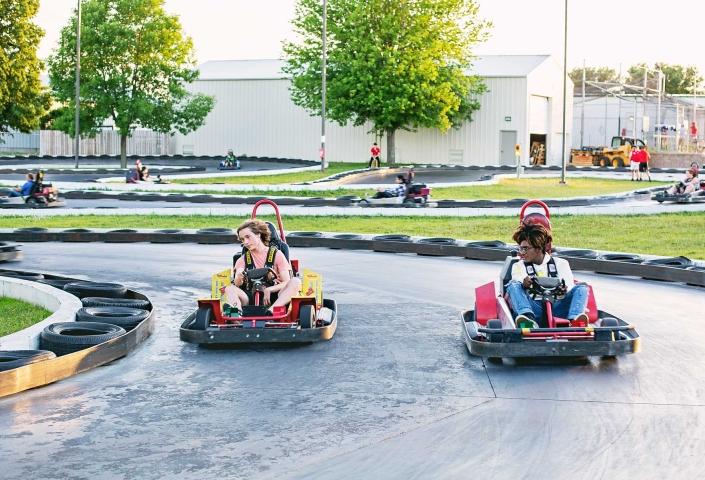 Teens driving go-karts at Thunder Road