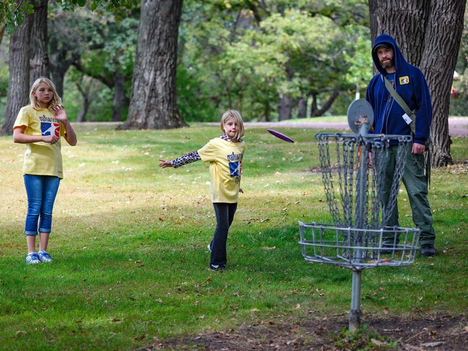 Little girls playing frisbee golf