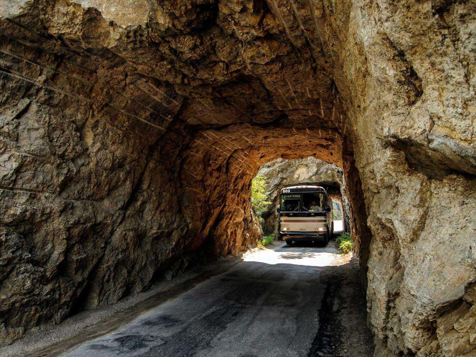 Bus driving through mountain tunnels