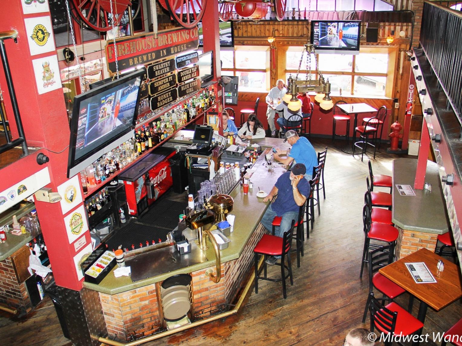 Patrons sitting at the bar in Firehouse Brewing Company