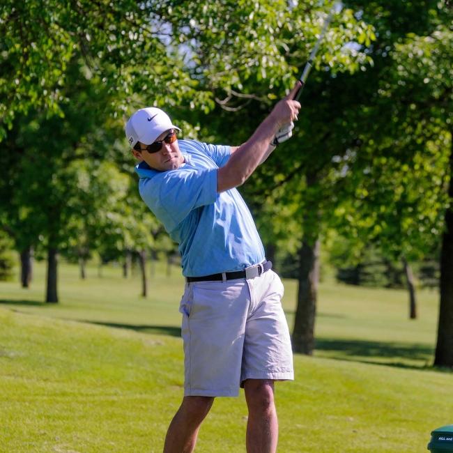 Man at Edgebrook Golf Course mid-golf swing