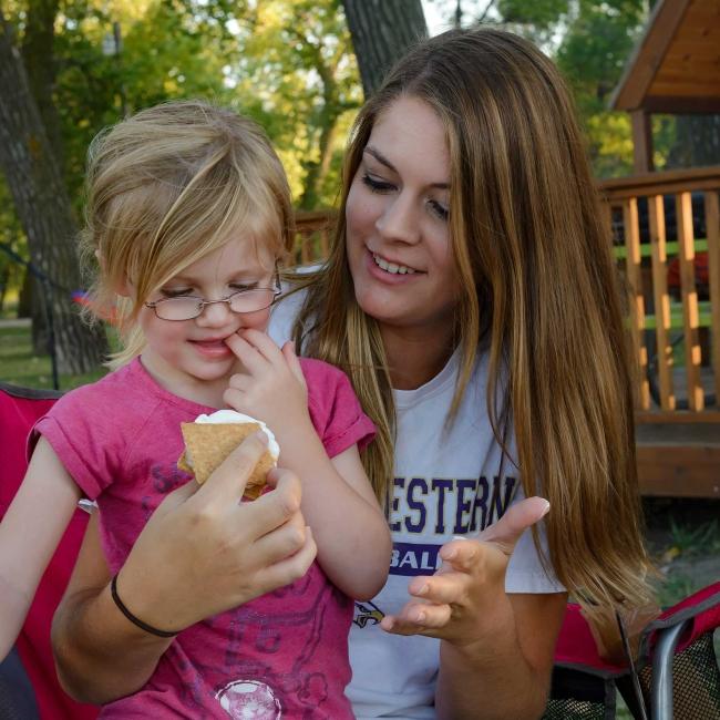 Mom and daughter eating s'mores