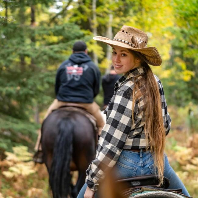 Two people horseback riding in Black Elk Wilderness