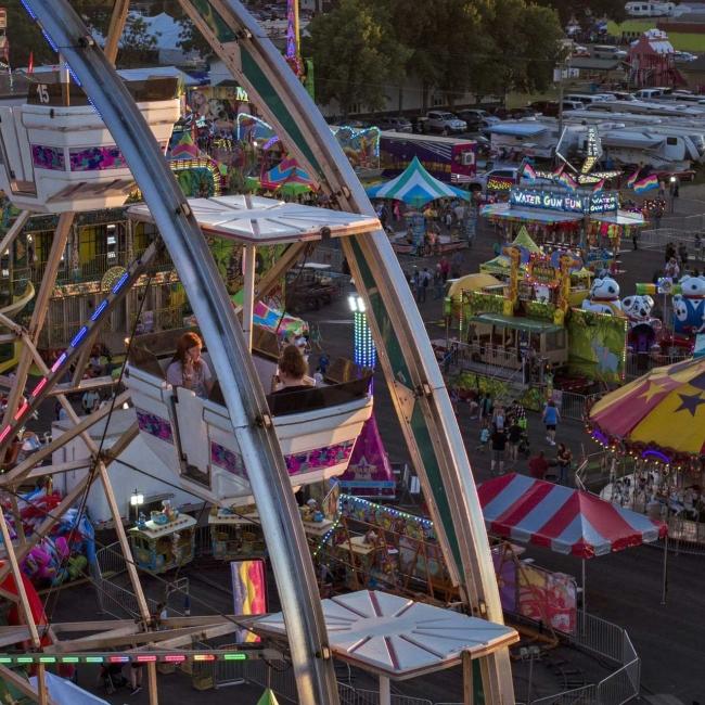 An aerial view of the South Dakota State Fair in Huron, including the ferris wheel, carousel, other rides and carnival games.