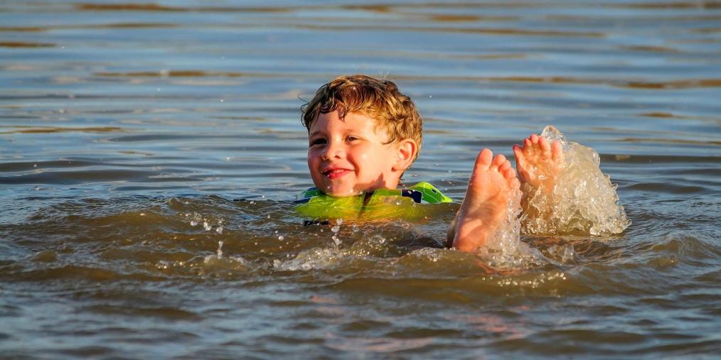 Boy floating on back in water