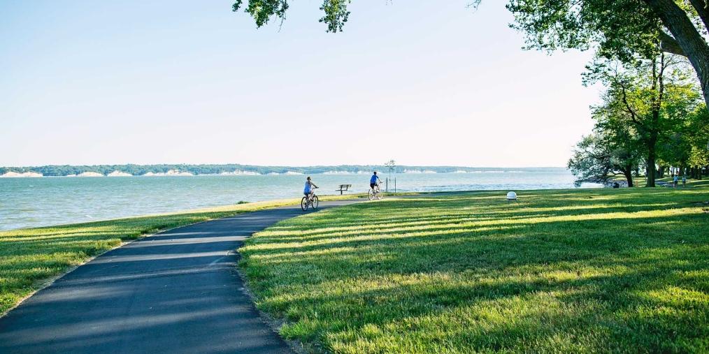 Biking along the water on a paved path