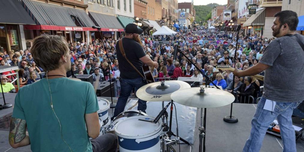 A street in Historic Deadwood is packed with people as a band performs at Wild Bill Days. Deadwood, South Dakota.