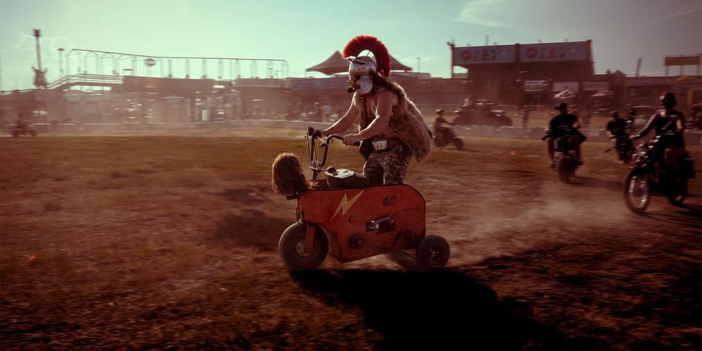 A man wearing a Trojan-style helmet rides a small motorcycle at the Sturgis Motorcycle Rally in Sturgis, South Dakota.