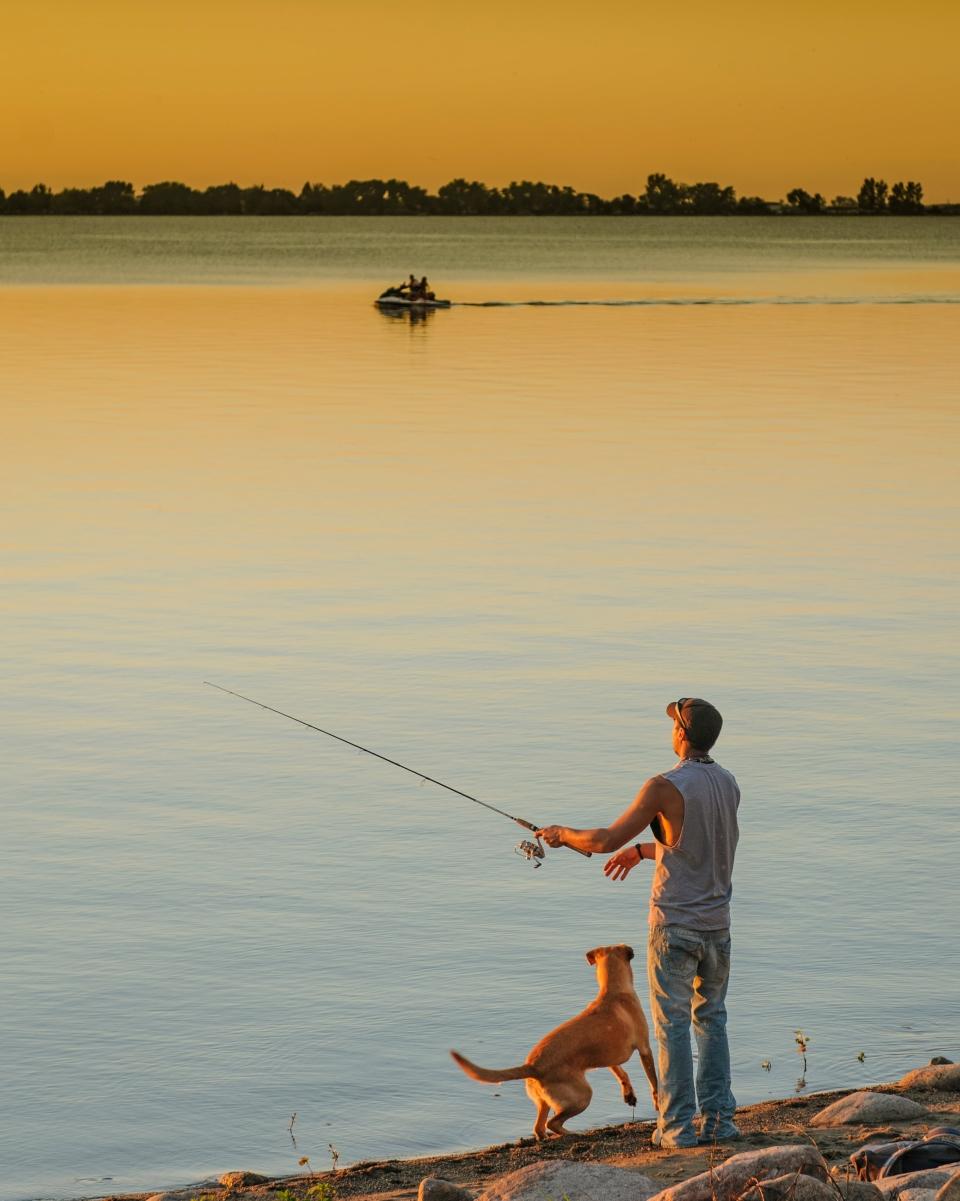 Fisherman and dog at Lake Kampeska