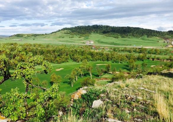 Trees cover much of this golf course that sits near the base of the Black Hills