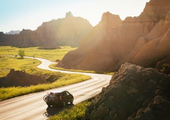 SUV driving along the Badlands Scenic Loop.