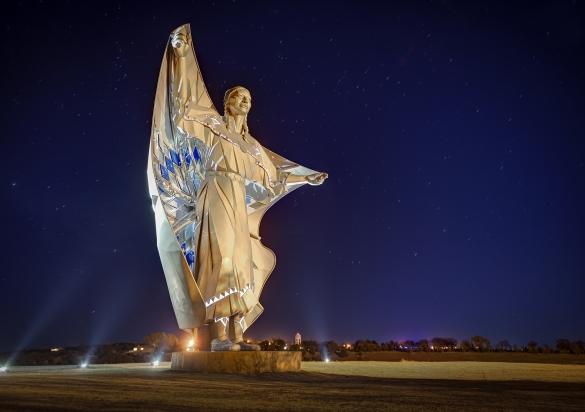 Dignity sculpture at night